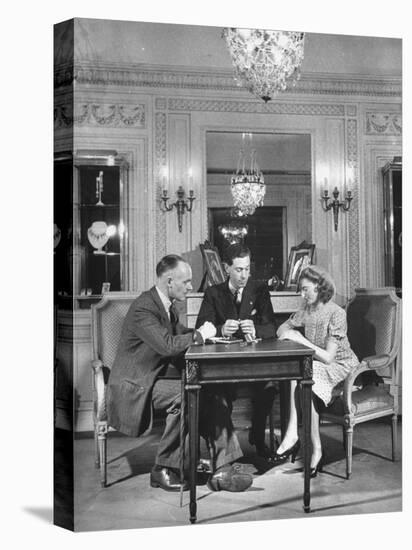 Salesman from Cartier Jewelers Helping a Couple Pick Out a Ring-null-Premier Image Canvas