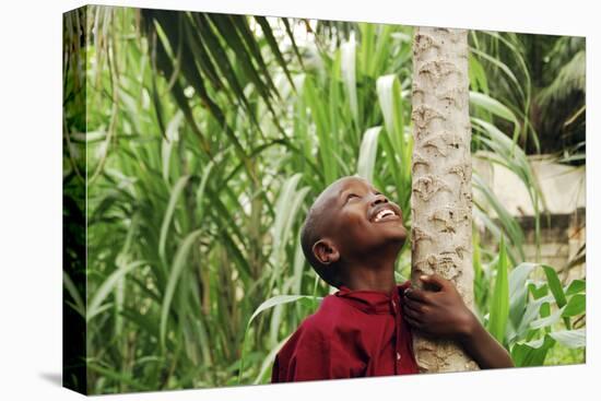 Schoolchild Embracing Tree Trunk and Looking Up, Bujumbura, Burundi-Anthony Asael-Premier Image Canvas