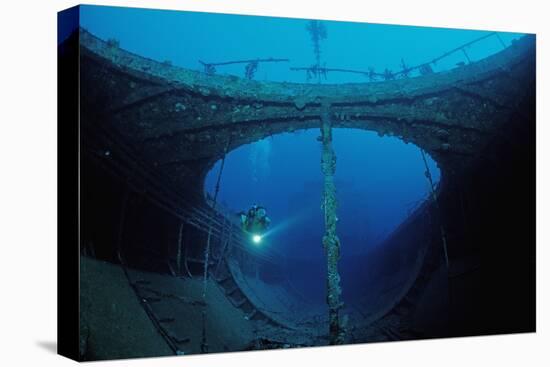 Scuba Diver Exploring a Shipwreck, Papua New Guinea, Coral Sea.-Reinhard Dirscherl-Premier Image Canvas