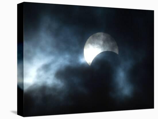 Seen Through Clouds the Sun is Partially Obscured by the Moon During an Eclipse-null-Premier Image Canvas