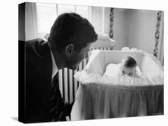 Sen. Jack Kennedy Admiring Baby Caroline as She Lies in Her Crib in Nursery at Georgetown Home-Ed Clark-Premier Image Canvas