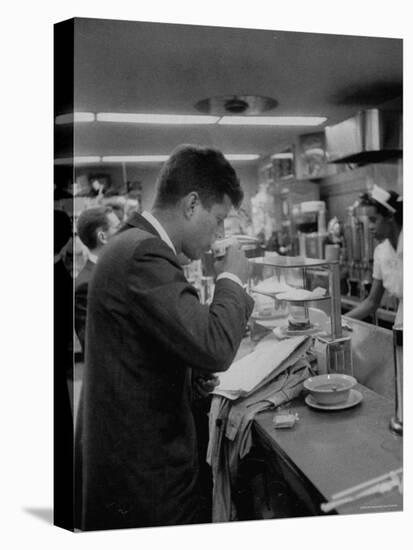 Senator John F. Kennedy Drinking a Cup of Coffee at a Cafe in Washington Airport-Ed Clark-Premier Image Canvas