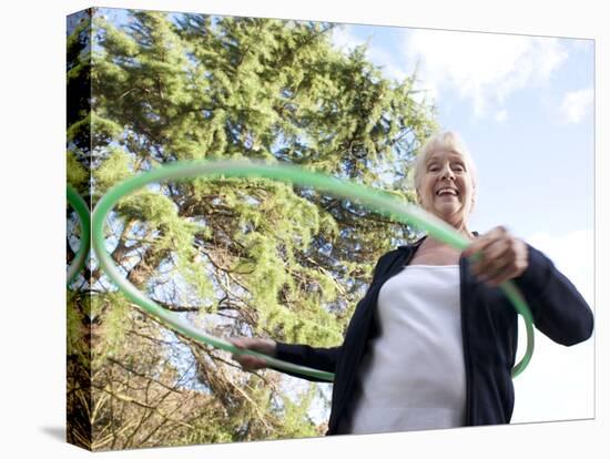 Senior Woman Hula-hooping-Science Photo Library-Premier Image Canvas
