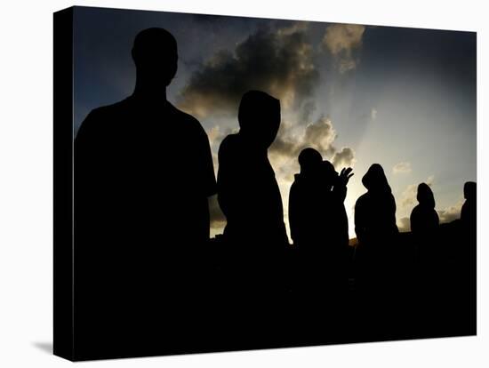 Several Africans Immigrants Chat at Sunset Outside of the Holding Centre for Immigrants-null-Premier Image Canvas