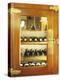 Several Wine Bottles in Wood-Panelled Drinks Cabinet-Peter Medilek-Premier Image Canvas