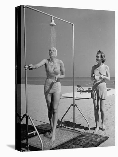 Shapely Sunbather Taking an Outdoor Shower as Woman Preparing for Her Turn, Looks On, at Beach-Alfred Eisenstaedt-Premier Image Canvas