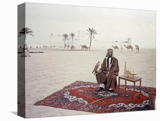 Sheikh Shakhbut Bin Sultan Al Nahyan Sitting in Front of His Palace Holding a Falcon, 1963-Ralph Crane-Premier Image Canvas