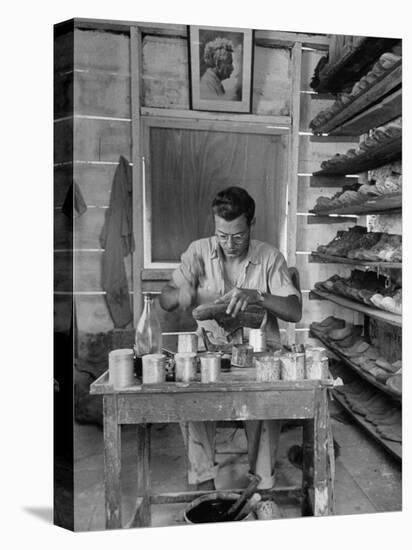 Shoemaker Sitting in His Shop Working on a Pair of Old Work Shoes-John Phillips-Premier Image Canvas