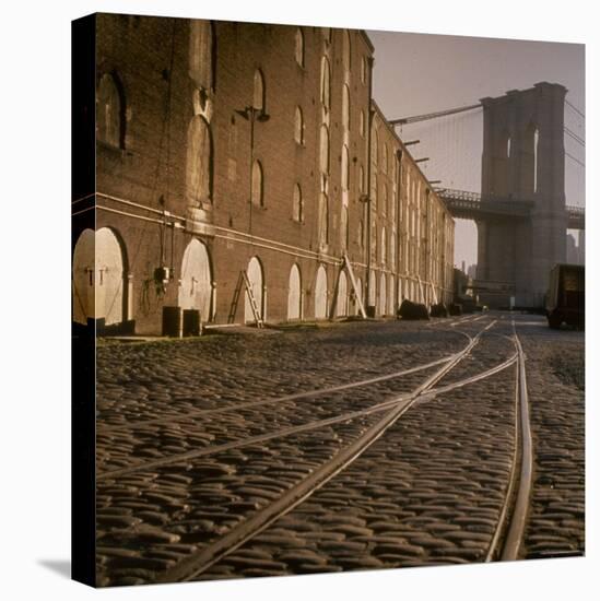 Shuttered Warehouses Lit by Sunlight on Trolley Track Railed Street Along Brooklyn Waterfront-Walker Evans-Premier Image Canvas