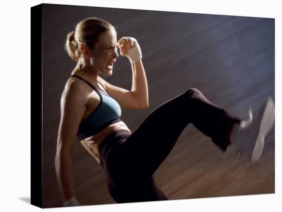 Side Profile of a Young Woman Kickboxing-null-Premier Image Canvas