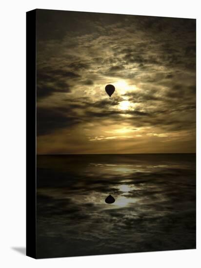 Silhouette of a Hot Air Balloon Over Water-null-Premier Image Canvas