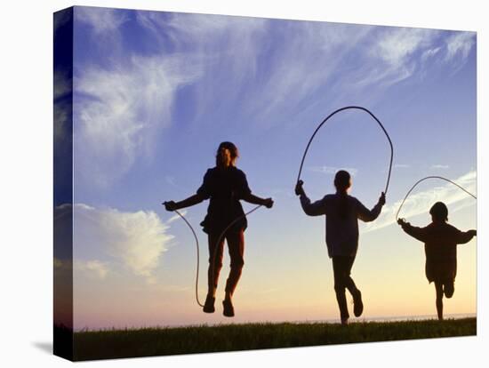 Silhouette of Children Jumping Rope Outdoors-Mitch Diamond-Premier Image Canvas