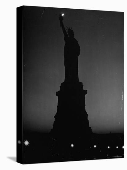 Silhouette of Statue of Liberty Lit by Two 200 Watt Lamps During Wartime Effort to Conserve Energy-Andreas Feininger-Premier Image Canvas