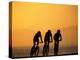 Silhouette of Three Men Riding on the Beach-Mitch Diamond-Premier Image Canvas