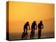 Silhouette of Three Men Riding on the Beach-Mitch Diamond-Premier Image Canvas