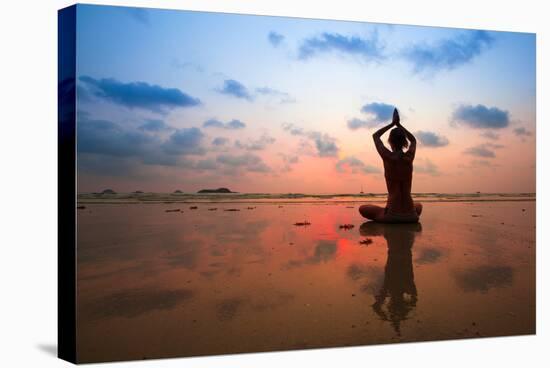 Silhouette Young Woman Practicing Yoga On The Beach At Sunset-De Visu-Stretched Canvas