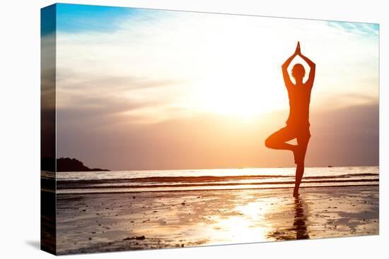 Silhouette Young Woman Practicing Yoga on the Beach at Sunset-De Visu-Premier Image Canvas