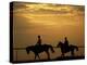 Silhouetted Men Riding on Horses, Dubai, UAE-Henry Horenstein-Premier Image Canvas