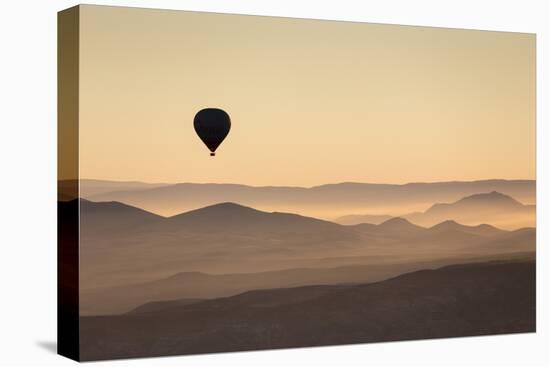 Single Hot Air Balloon over a Misty Dawn Sky, Cappadocia, Anatolia, Turkey, Asia Minor, Eurasia-David Clapp-Premier Image Canvas