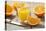 Sliced Oranges and Glass with Fresh Orange Juice-Jana Ihle-Premier Image Canvas