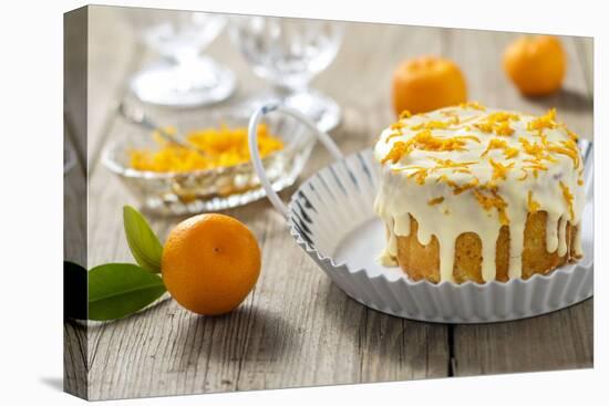 Small Orange Cake with White Icing on Wooden Table-Jana Ihle-Premier Image Canvas