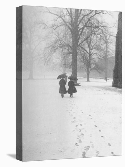 Snow Falling While People Take a Stroll Across Campus of Winchester College-Cornell Capa-Premier Image Canvas