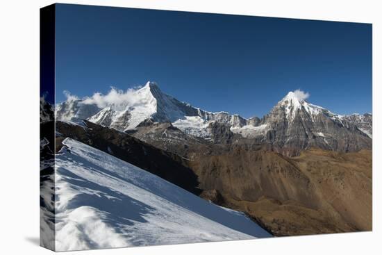 Snow on the Nyile La, a 4950m pass, and the peak of Jitchu Drake at 6714m in the distance, Bhutan,-Alex Treadway-Premier Image Canvas