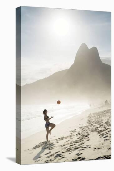 South America, Brazil, Rio de Janeiro, a woman practising football or altinha on Ipanema beach (MR)-Alex Robinson-Premier Image Canvas