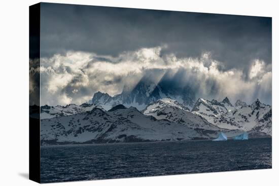 South Georgia Island. Opening in clouds and Virga reveal the mountainous and glaciated landscape.-Howie Garber-Premier Image Canvas