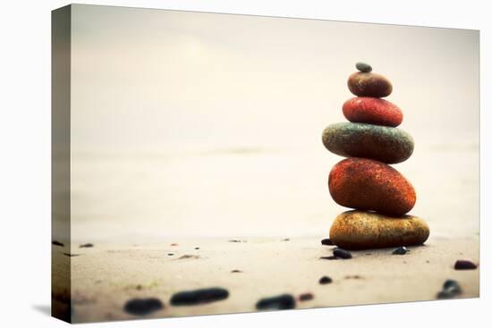 Stones Pyramid on Sand Symbolizing Zen, Harmony, Balance. Ocean in the Background-Michal Bednarek-Premier Image Canvas