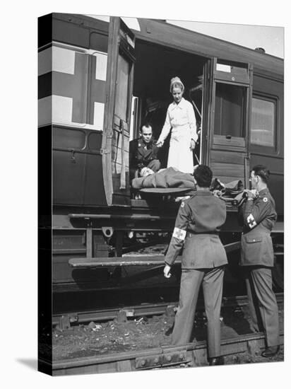 Stretcher Men Passing in a Case to Be Checked by Army Nurse-null-Premier Image Canvas