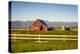 Summer Evening with a Red Barn and Silos in Rural Montana with Rocky Mountains in the Background.-Nick Fox-Premier Image Canvas