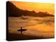 Surfer Standing at Waimea Bay at Sunset, Waimea, U.S.A.-Ann Cecil-Premier Image Canvas