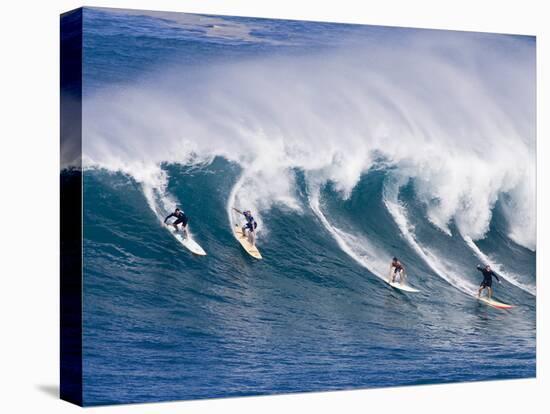 Surfers Ride a Wave at Waimea Beach on the North Shore of Oahu, Hawaii-null-Premier Image Canvas