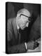 Swiss Architect Le Corbusier Leaning Down to Write with His Glasses Pushed Back on His Forehead-null-Premier Image Canvas