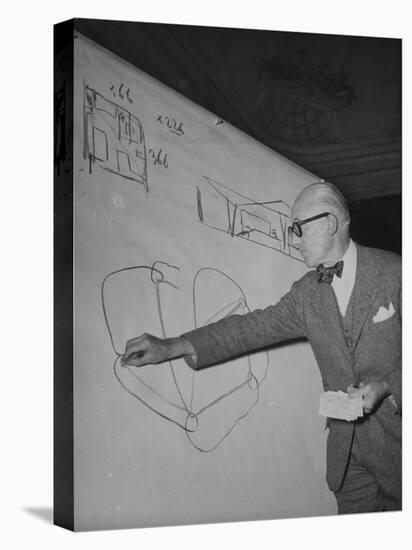 Swiss Architect Le Corbusier Standing on Stage with Notes in His Hand and Drawing on Sketch Pad-null-Premier Image Canvas