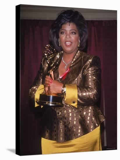 Talk Show Host Oprah Winfrey Holding Emmy Award-null-Premier Image Canvas