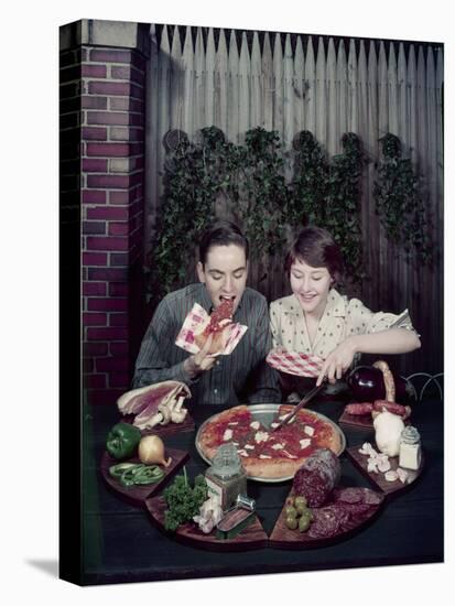 Teen Couple Eating Pizza from a Garden Table, 1960-Eliot Elisofon-Premier Image Canvas