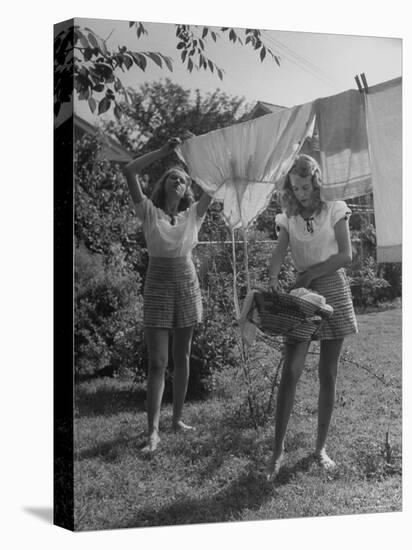 Teenage Twin Girls Hanging Laundry on Clothesline-Nina Leen-Premier Image Canvas