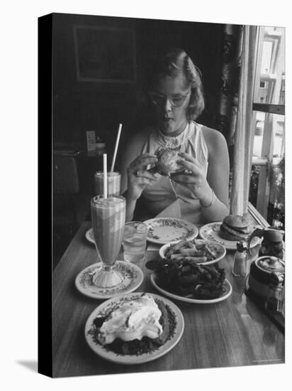 Teenaged Girl Sitting in Drugstore Eating a Hamburger-Hank Walker-Premier Image Canvas