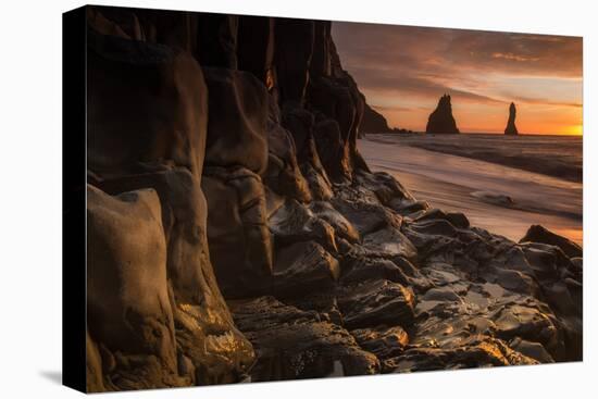 The basalt rock formations in the sea on Reynisfjara Beach in Vik, Iceland at sunrise.-Alex Saberi-Premier Image Canvas