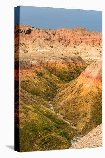 The grassy valley with dry creek is fed by the run off of the hoodoos lining the side.-Sheila Haddad-Premier Image Canvas