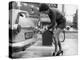 The Modern Female Petrol Pump Operator Refuelling a Car in Her Mini Skirt-null-Premier Image Canvas