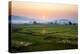 The Sun Sets Behind Foggy Hills and Expansive Rice Paddy Fields Near Chiang Mai, Thailand-Dan Holz-Premier Image Canvas