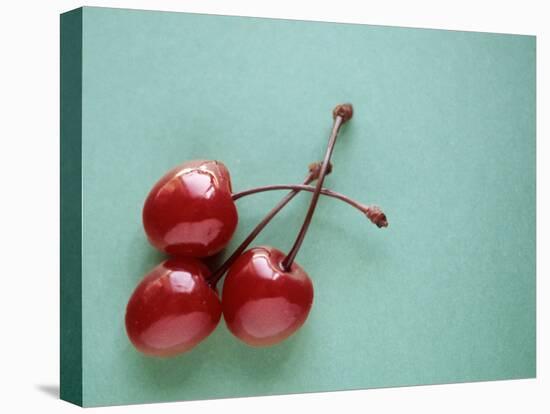 Three Cherries on a Green Background-Karen M^ Romanko-Premier Image Canvas