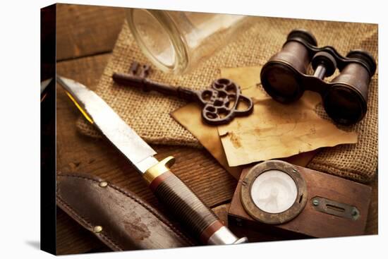 Treasure Hunting Setting, A Compass, Binoculars, Knife and a Old Key on a Old Wooden Desk-landio-Premier Image Canvas