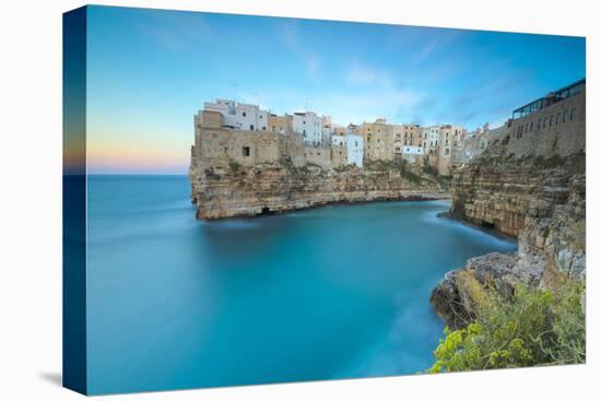 Turquoise sea at sunset framed by the old town perched on the rocks, Polignano a Mare, Province of -Roberto Moiola-Premier Image Canvas