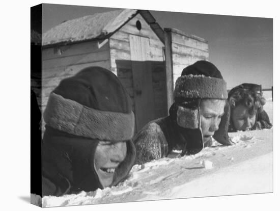 Two Boys and a Girl Up to Their Necks in a Snowdrift,Nibbling at the Snow-George Silk-Premier Image Canvas