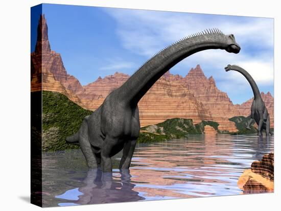 Two Brachiosaurus Dinosaurs in Water Next to Red Rock Mountains-null-Stretched Canvas