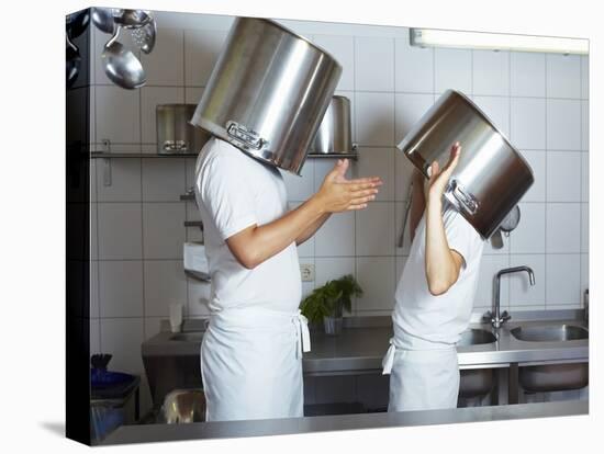 Two Chefs Having Discussion with Large Pans on their Heads-Robert Kneschke-Premier Image Canvas